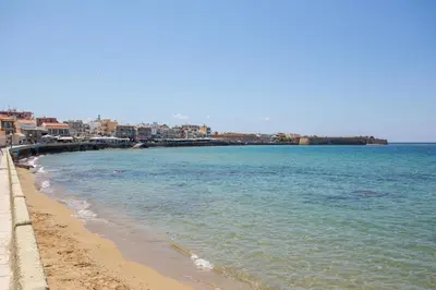 a view of a beach with buildings and the ocean at Sea View Penthouse with Roof Garden in Chania Town