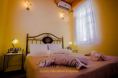 a bedroom with a bed with pink towels on it at Villa Milli in Chania Town