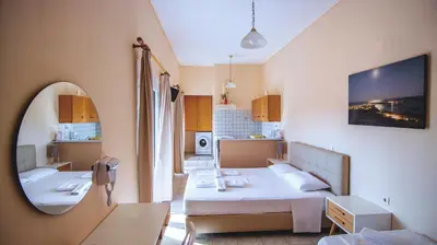 a small room with a bed and a mirror at Oriental Bay in Palaiochóra