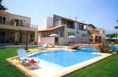a swimming pool in front of a house at Vamos Palace Apartments in Vamos