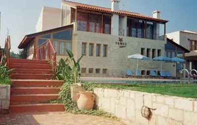 a large house with stairs leading up to it at Vamos Palace Apartments in Vamos