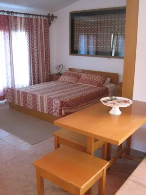 a living room with a bed and a table and a table sidx sidx at Vamos Palace Apartments in Vamos