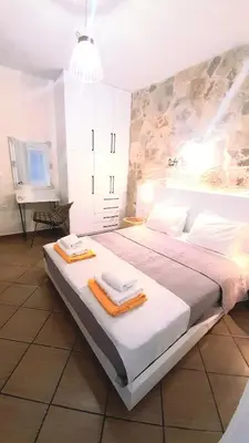 a bedroom with a large bed with towels on it at Apartment Split Level in Chania Town
