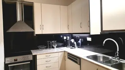 a kitchen with white cabinets and a sink at Apartment Split Level in Chania Town