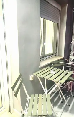 a table and a chair in a room with a window at Apartment Split Level in Chania Town