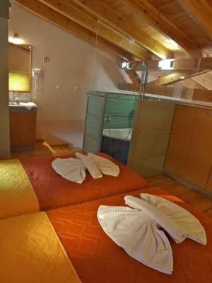 two beds with towels on them in a room at Sorta Apartments in Kato Daratso