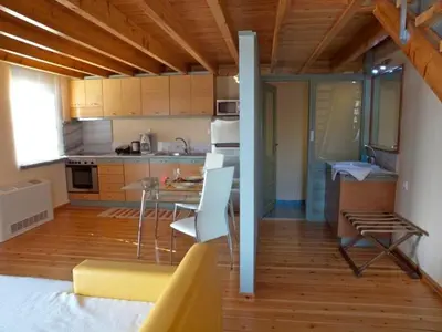 a kitchen with a table and chairs in a room at Sorta Apartments in Kato Daratso