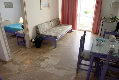 a living room with a couch and a table at Doreen Suites in Kalamaki Chanion