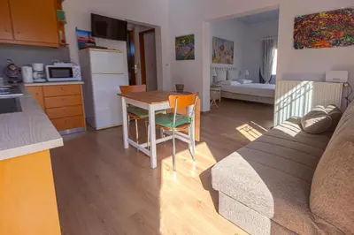 a kitchen and living room with a couch and a table at In And Out in Chania Town