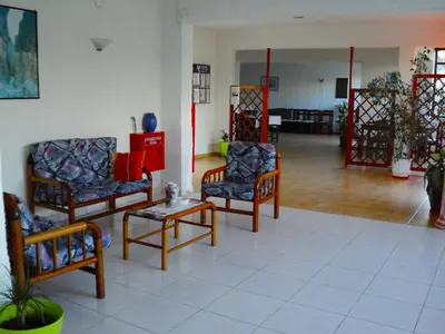 a living room with two chairs and a table at Thodorou Villa in Agia Marina Nea Kydonias