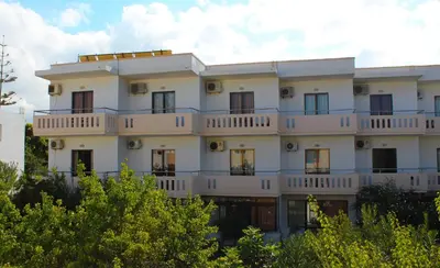 a white building with balconies on the side of it at Thodorou Villa in Agia Marina Nea Kydonias
