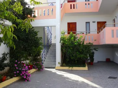 a building with stairs and flowers in front of it at Thodorou Villa in Agia Marina Nea Kydonias