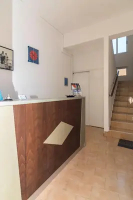 an office with a desk and stairs in a building at Sifis Studios in Palaiochóra