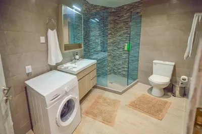 a bathroom with a washing machine and a toilet at Koukis House With Sea View in Falasarna