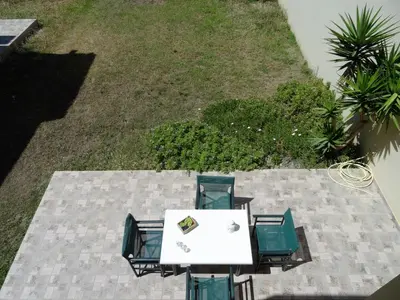 an overhead view of a table and chairs on a patio at Platanias House on the Beach in Plataniás