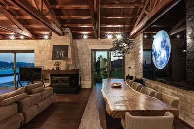 a living room with a table and a piano at Elements Villa in Galangádhos