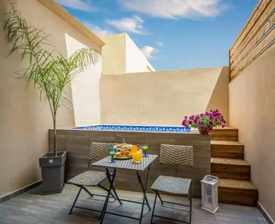 a patio with a table and chairs on a balcony at Aretousa Suites in Chania Town