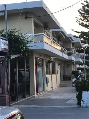 a building with a balcony on top of it at Neapolis Apartments in Palaiochóra