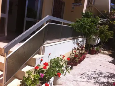a bunch of potted plants on the stairs of a building at Neapolis Apartments in Palaiochóra