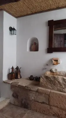 a room with tea pots on a wall at Bendeni Cottage in Megála Khoráfia