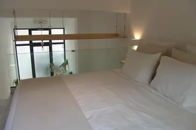 a white bed with white sheets and pillows in a room at Sixteen All Seasons House in Chania Town