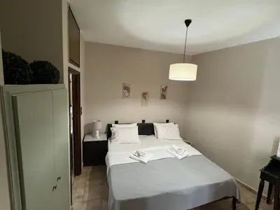 a bedroom with a bed with two books on it at Nicolas Beach in Palaiochóra