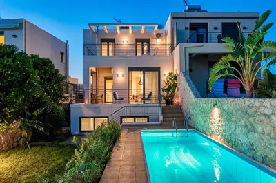 a house with a swimming pool in front of it at Villa Anemi in Stérnai