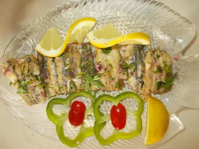 a plate of food with fish and vegetables on it at Hippokratis Apartments in Gerani Chanion