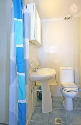 a small bathroom with a sink and a toilet at Akrogiali in Kissamos