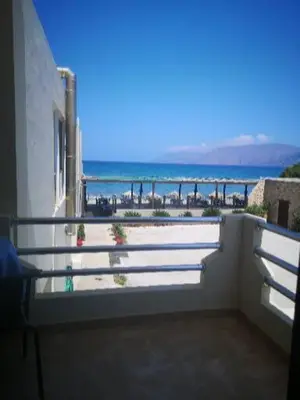 a balcony of a building with a view of the ocean at Akrogiali in Kissamos