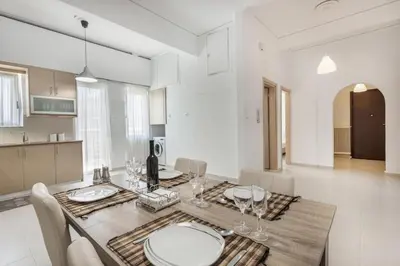 a kitchen and dining room with a table and chairs at Mirsini's Apartment in Chania center in Chania Town