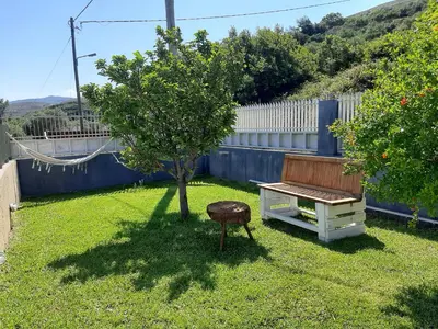 a bench and a tree in a yard at Villa Aeolus with private overflow, endless, heated pool in Prinés