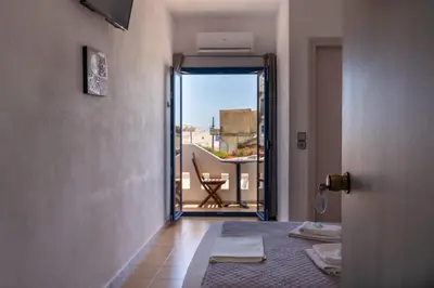 a room with a door to a balcony with a view at Giannis Rooms in Agia Roumeli