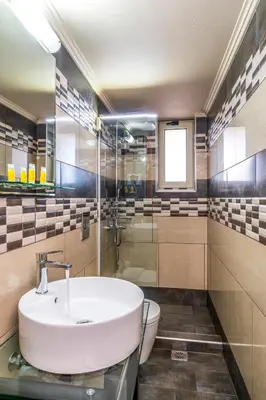 a bathroom with a sink and a toilet at Areti Suites in Kathiana