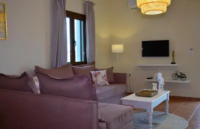 a living room with a couch and a table at Elianthos Villas in Vamos