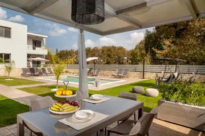 a patio with a table with fruit on it at Kagiemar Luxury House in Perivólia