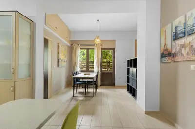 a kitchen and dining room with a table and chairs at Casa Veranda - 3 Bedroom House with BBQ & Backyard in Chania Town