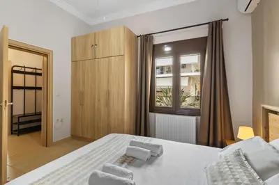 a bedroom with a bed and a window at Casa Veranda - 3 Bedroom House with BBQ & Backyard in Chania Town