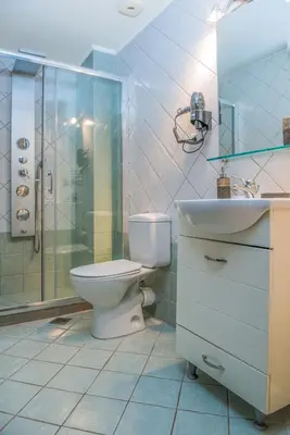 a bathroom with a toilet and a sink and a shower at Pilot Lux Apartment in Chania Town