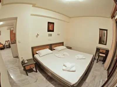 a bedroom with a bed with two towels on it at Alexandros M in Maleme