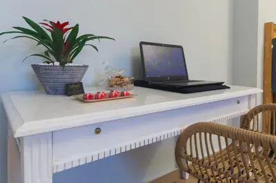 a laptop computer sitting on top of a white desk at Dome Rooms Downtown in Chania Town