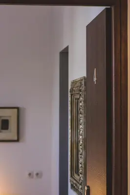 a wooden door in a room with a mirror at Dome Rooms Downtown in Chania Town