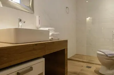 a bathroom with a sink and a toilet at Dome Rooms Downtown in Chania Town