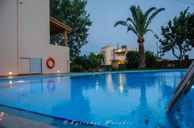 a swimming pool in a villa at night at Flisvos Rooms in Palaiochóra