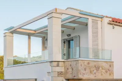 a glass facade of a house with a window at Ontas Villa Loutraki Platanias in Gerani Chanion