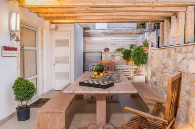a room with a wooden table and chairs in a building at Ontas Villa Loutraki Platanias in Gerani Chanion