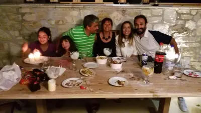 a group of people sitting around a table at Ontas Villa Loutraki Platanias in Gerani Chanion