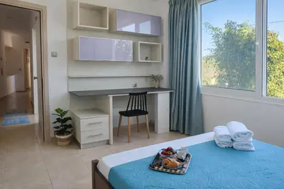 a bedroom with a bed with a tray of food on it at Konstantina's cottage Ideal BaseforBalos & Elafonisi in Kissamos