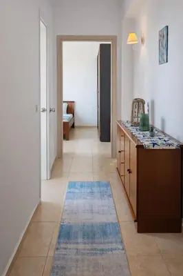a hallway with a kitchen with a blue rug at Konstantina's cottage Ideal BaseforBalos & Elafonisi in Kissamos