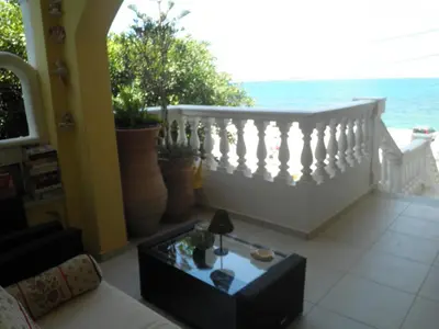 a living room with a white railing and a table at Dimitra's Sea-Crafts Boutique Studios in Kalyves